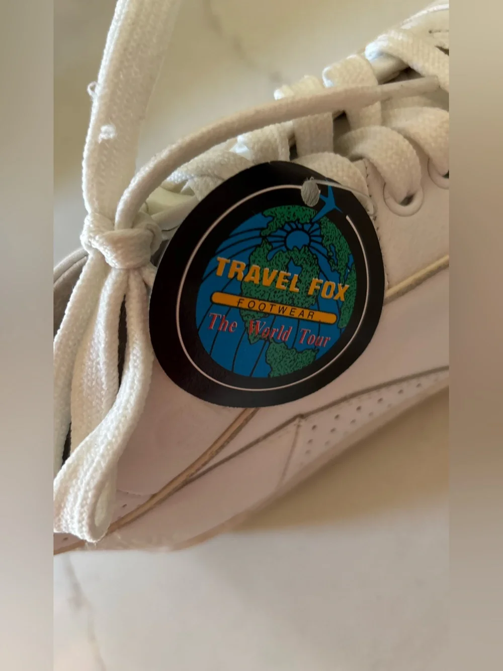 Travel Fox white sneakers size 7 back tab has a tear